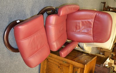 Lot 1362 - An Ekornes bentwood red upholstered Stressless recliner with foot stool