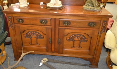 Lot 1364 - An Arts & Craft oak sideboard, carved with stylised flower and brass handles, 152cm by 54cm by 95cm