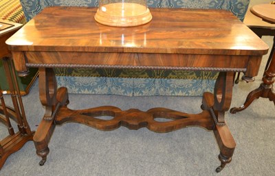 Lot 1369 - An early 19th century rosewood library table, lyre ends, shaped stretcher, turned supports to...