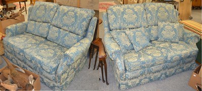 Lot 1373 - A pair of blue upholstered two-seater wing backed sofas, 155cm by 100cm by 88cm high