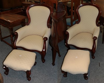 Lot 1377 - A pair of reproduction hardwood Victorian style armchairs with matching footstools