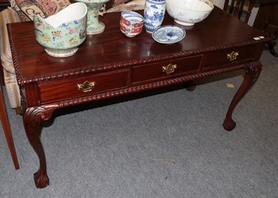 Lot 1382 - A reproduction hardwood three-drawer hall table on cabriole legs, 140cm wide