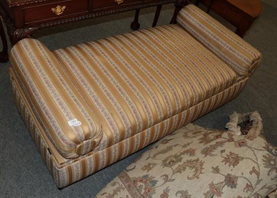 Lot 1383 - An upholstered box Ottoman with overstuffed arm supports and a hinged seat