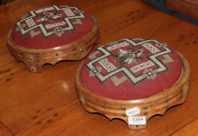 Lot 1384 - A pair of Victorian circular walnut footstools with bead work tops