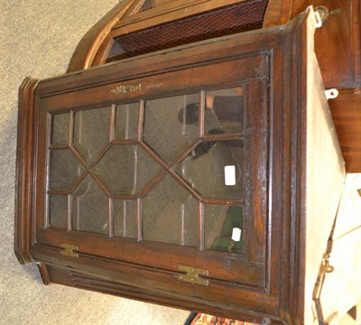 Lot 1403 - A George III astragal glazed corner cupboard