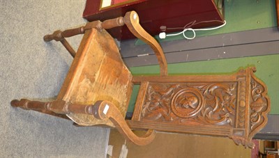 Lot 1406 - A late Victorian carved oak armchair