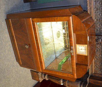 Lot 1407 - A 1940's walnut cocktail cabinet with integral clock