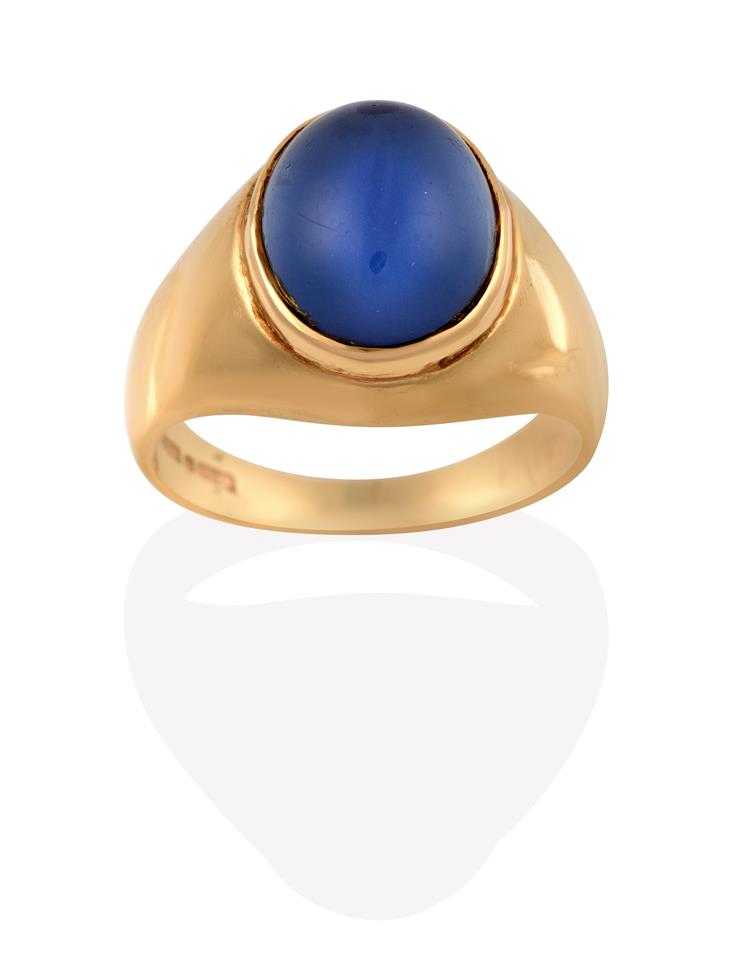 Lot 2000 - A 14 Carat Gold Synthetic Sapphire Ring, the cabochon synthetic star sapphire in a yellow...