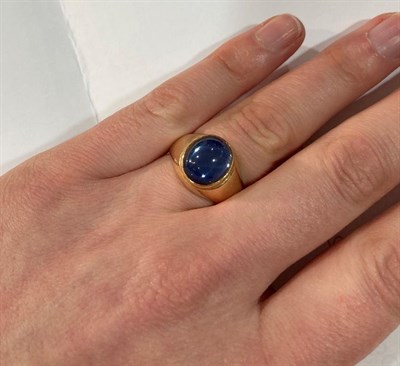 Lot 2000 - A 14 Carat Gold Synthetic Sapphire Ring, the cabochon synthetic star sapphire in a yellow...
