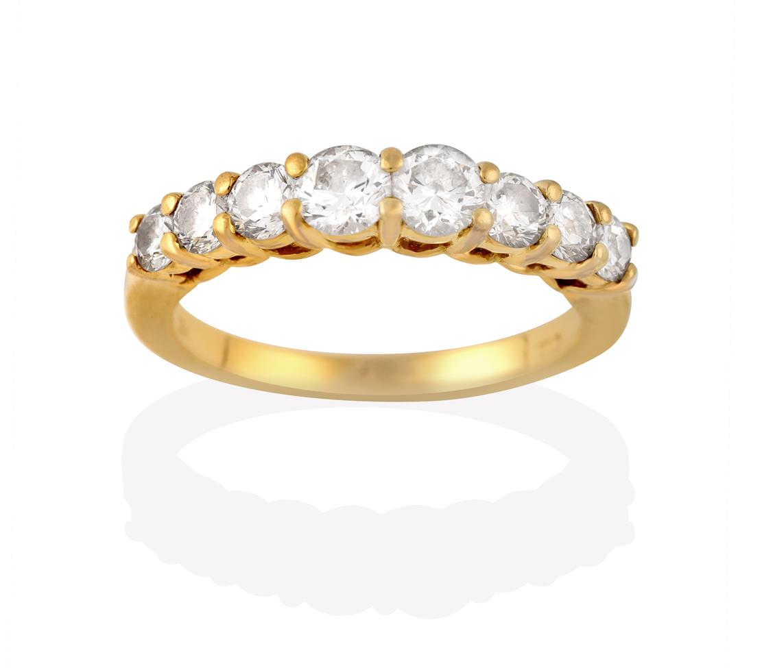 Lot 2014 - A Diamond Eight Stone Ring, the graduated round brilliant cut diamonds, in yellow claw settings, to