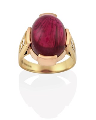 Lot 2017 - An 18 Carat Gold Pink Tourmaline Ring, the oval cabochon pink tourmaline in a yellow claw...