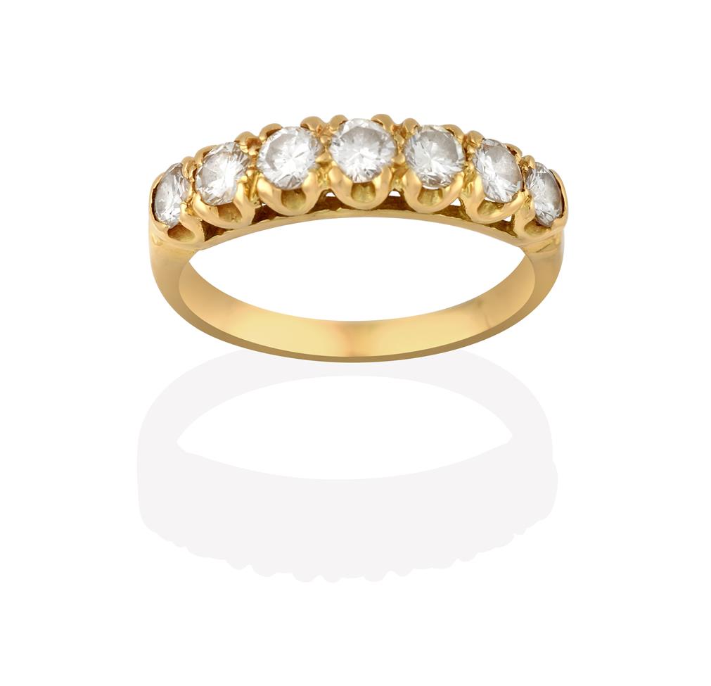 Lot 2024 - A Diamond Seven Stone Ring, the graduated round brilliant cut diamonds in yellow claw settings,...