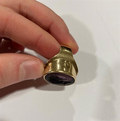 Lot 2025 - A 9 Carat Gold Glass Intaglio Ring, the purple glass carved to depict a gentleman in a yellow...