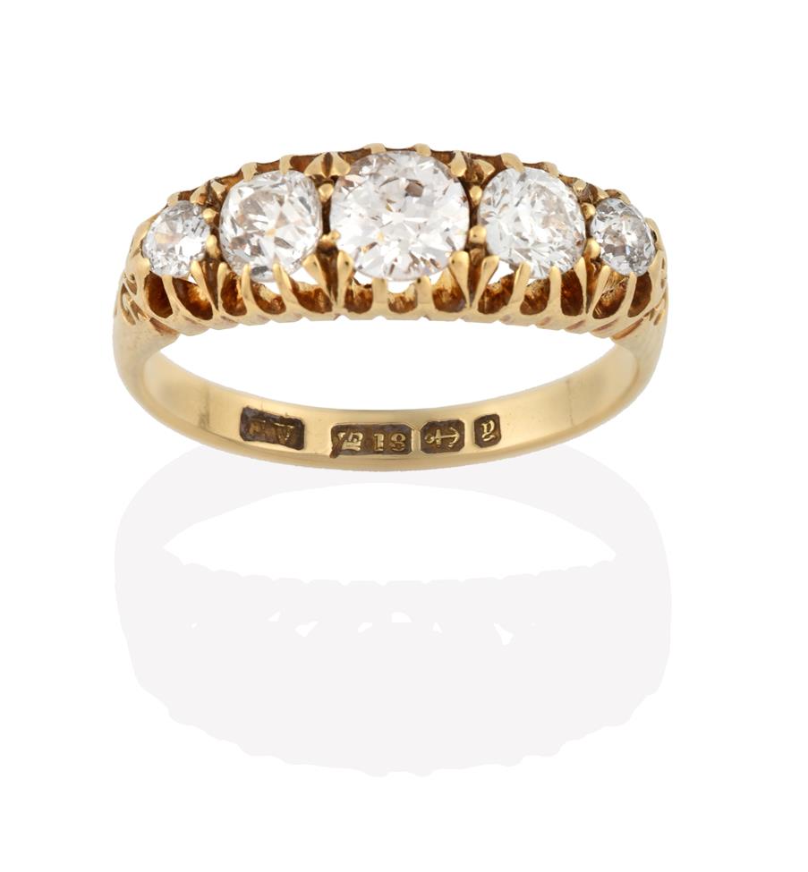 Lot 2026 - An 18 Carat Gold Diamond Five Stone Ring, the graduated old cut diamonds in yellow claw...