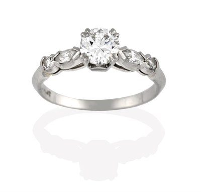 Lot 2038 - A Diamond Solitaire Ring, the round brilliant cut diamond in a white claw setting, to a...