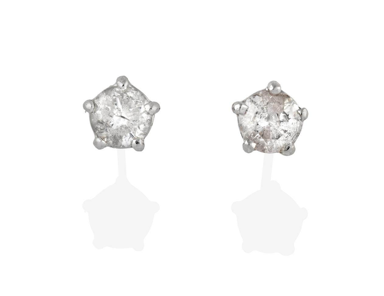 Lot 2045 - A Pair of Diamond Solitaire Earrings, the round brilliant cut diamonds in white claw settings,...