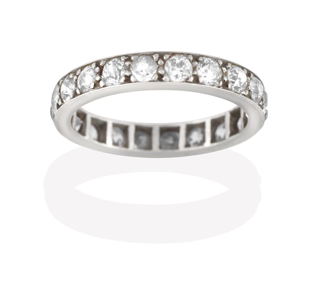 Lot 2048 - A Diamond Eternity Ring, the twenty old cut diamonds in white claw and channel settings, total...