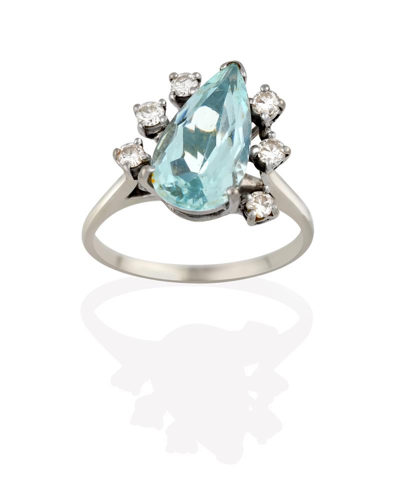 Lot 2051 - An Aquamarine and Diamond Ring, the pear cut aquamarine flanked by trios of round brilliant cut...