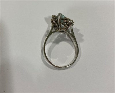 Lot 2051 - An Aquamarine and Diamond Ring, the pear cut aquamarine flanked by trios of round brilliant cut...