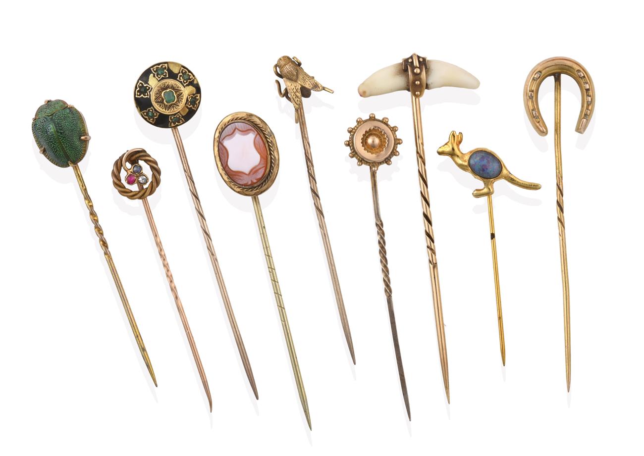 Lot 2064 - A Collection of Nine Stickpins, comprising of a cornelian cameo shield example; a scarab...