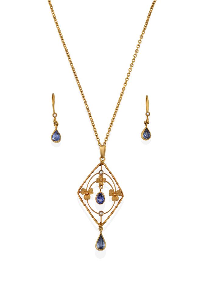 Lot 2065 - An Edwardian Sapphire and Seed Pearl Pendant on Chain, of openwork foliate lozenge design, with...