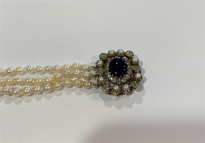 Lot 2072 - A Three Row Cultured Pearl Necklace, the 79:85:88 cultured pearls knotted to an oval clasp...