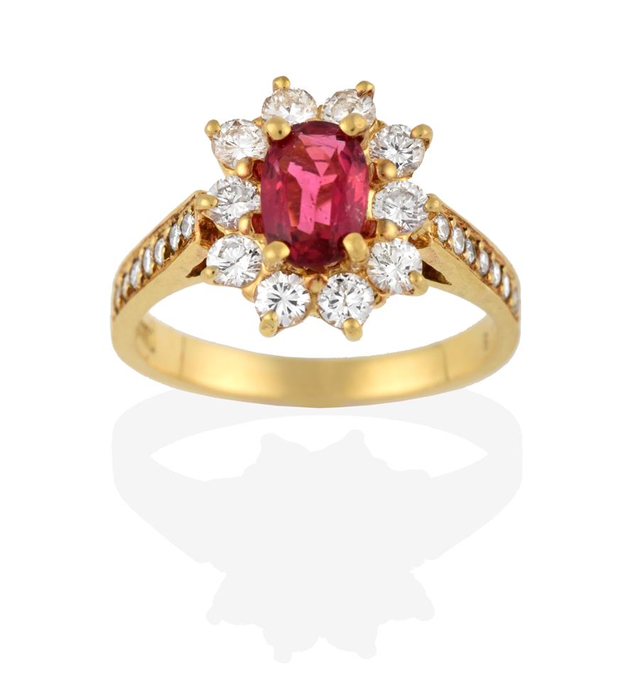 Lot 2074 - A Pink Tourmaline and Diamond Cluster Ring, the oval cut pink tourmaline within a border of...