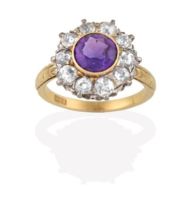 Lot 2076 - An Amethyst and Diamond Cluster Ring, the round cut amethyst in a yellow rubbed over setting,...