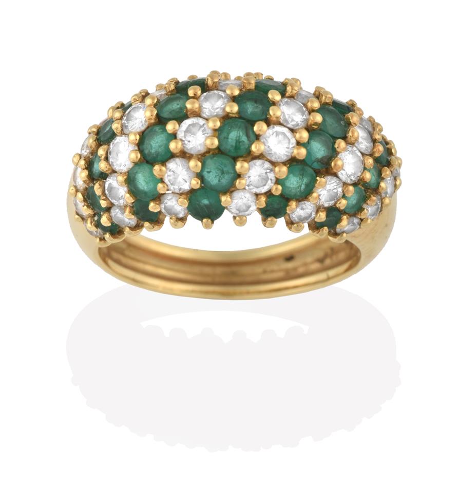 Lot 2081 - An Emerald and Diamond Ring, formed of eleven alternate rows of round brilliant cut diamonds...
