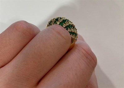 Lot 2081 - An Emerald and Diamond Ring, formed of eleven alternate rows of round brilliant cut diamonds...