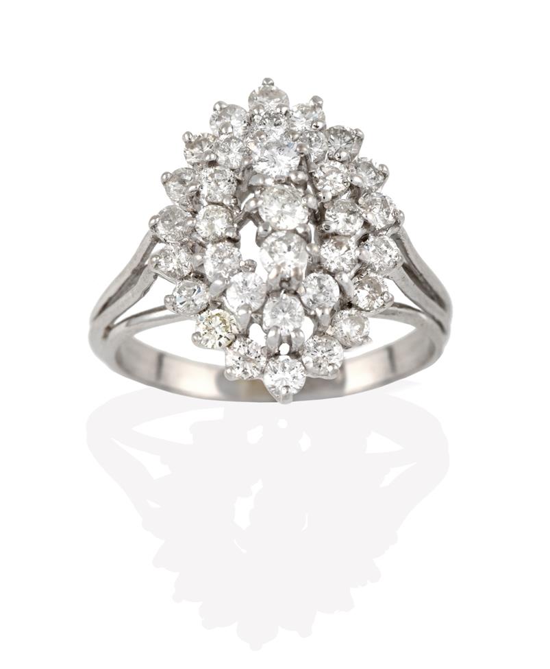 Lot 2086 - A Diamond Cluster Ring, three round brilliant cut diamonds within a double stepped border of...