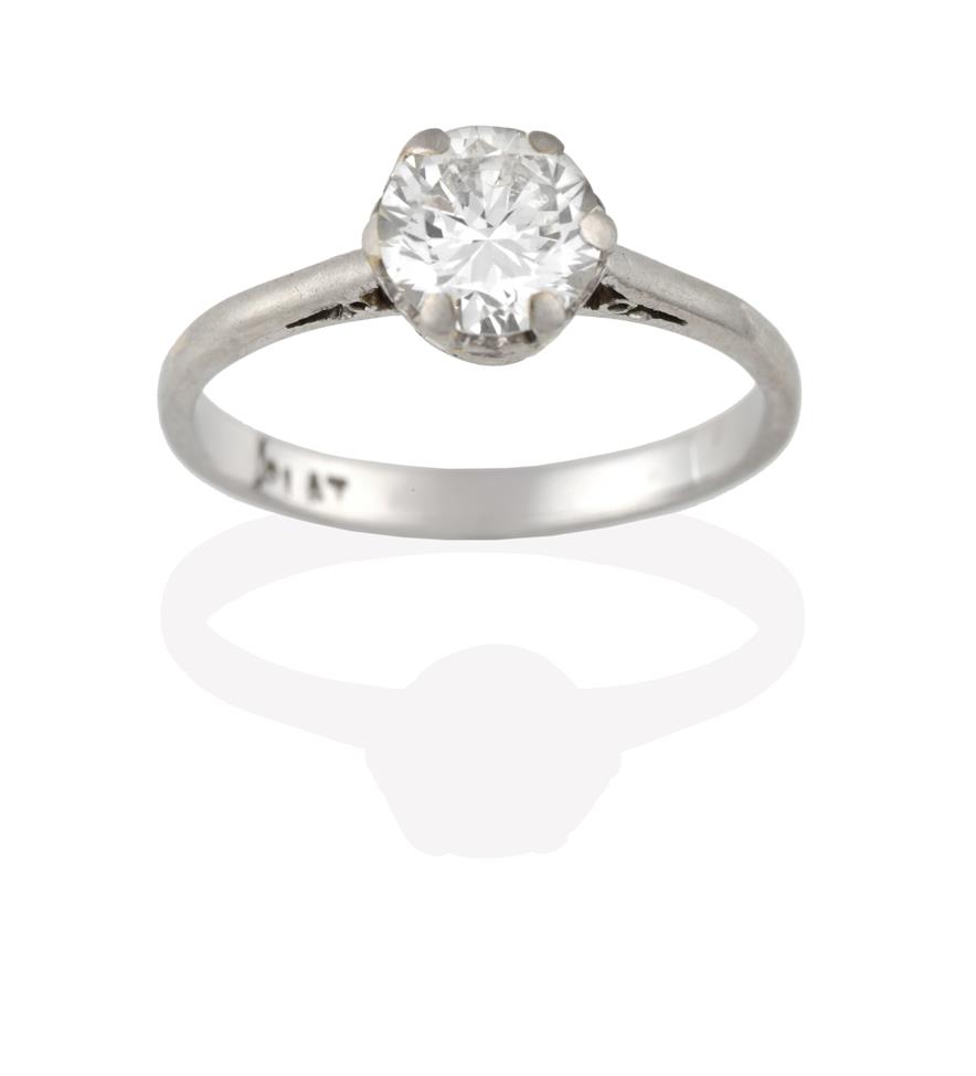 Lot 2088 - A Diamond Solitaire Ring, the old cut diamond in a white claw setting, to a tapered shoulder...
