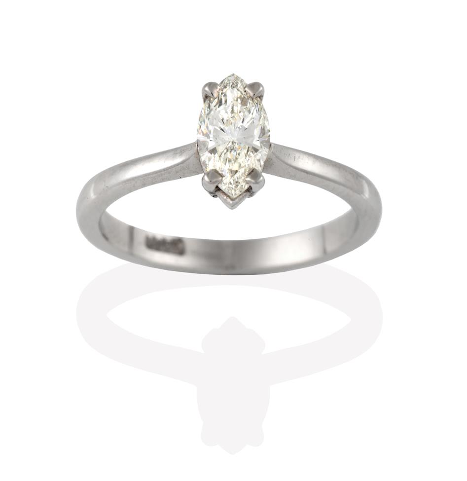 Lot 2092 - A Diamond Solitaire Ring, the marquise cut diamond in a white claw setting, to a tapered...