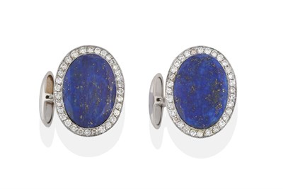 Lot 2096 - A Pair of Lapis Lazuli and Diamond Cufflinks, the oval lapis lazuli plaque within a border of...