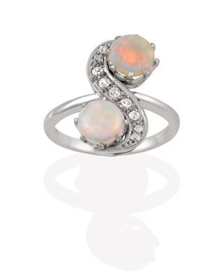 Lot 2098 - An Opal and Diamond Ring, the S-shaped twist composed of old cut diamonds terminating to round...