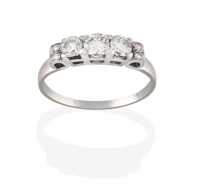 Lot 2103 - A Diamond Three Stone Ring, the graduated round brilliant cut diamonds in white claw settings,...