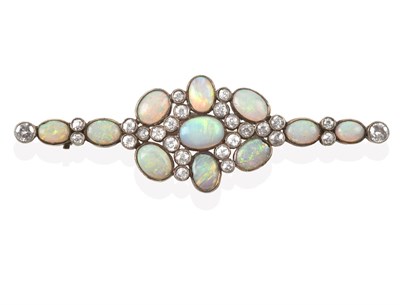 Lot 2107 - An Opal and Diamond Brooch, the central cluster formed of seven oval cabochon opals spaced by...