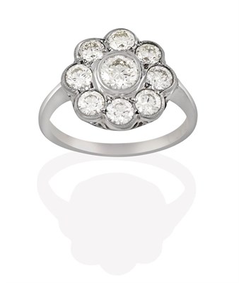 Lot 2114 - A Diamond Cluster Ring, the round brilliant cut diamond within a border of smaller round...