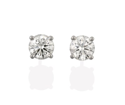 Lot 2121 - A Pair of 18 Carat White Gold Diamond Solitaire Earrings, the round brilliant cut diamonds in...