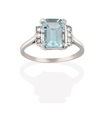 Lot 2130 - An Aquamarine and Diamond Ring, the emerald-cut aquamarine in a white claw setting, flanked by...