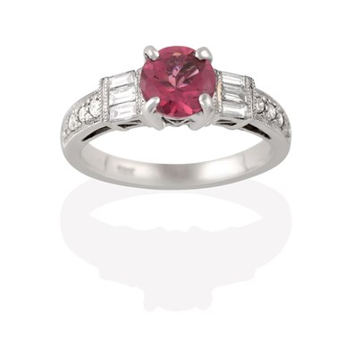 Lot 2131 - A Tourmaline and Diamond Ring, the round cut pink tourmaline flanked by trios of baguette cut...