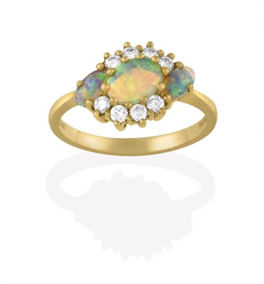 Lot 2136 - An 18 Carat Gold Opal and Diamond Cluster Ring, the three oval cabochon opals within a border...