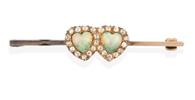 Lot 2137 - An Edwardian Opal and Diamond Brooch, two heart shaped cabochon opals within a border of old...
