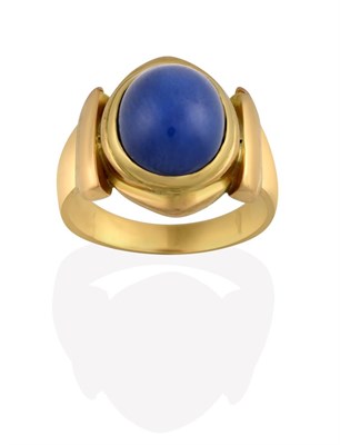 Lot 2147 - A Synthetic Star Sapphire Ring, the oval cabochon synthetic star sapphire in a yellow rubbed...
