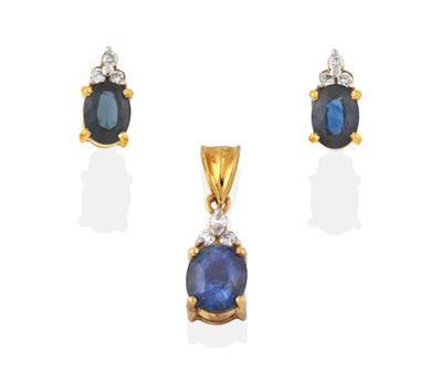 Lot 2155 - A Sapphire and Diamond Pendant, a trio of round brilliant cut diamonds in white claw settings...