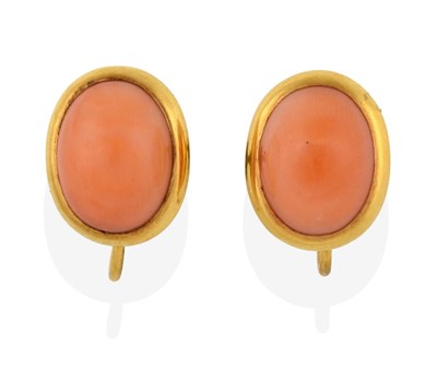 Lot 2157 - A Pair of Coral Earrings, the oval cabochon coral in yellow rubbed over settings, with screw...