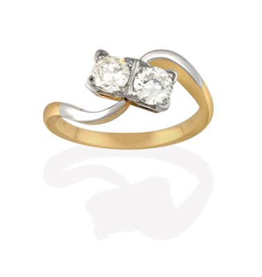 Lot 2163 - A Diamond Two Stone Twist Ring, the round brilliant cut diamonds in white claw and millegrain...