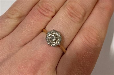 Lot 2171 - A Diamond Cluster Ring, the central raised round brilliant cut diamond within a border of...