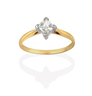 Lot 2172 - A Diamond Solitaire Ring, the princess cut diamond in a white four claw setting, to a yellow...