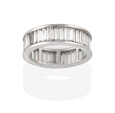 Lot 2184 - A Diamond Eternity Ring, the baguette cut diamonds in white channel settings, total estimated...